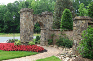 Flowers, shrubs, walkway, and stone arch in Charlotte