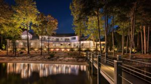 night view of large home's landscaping lake with